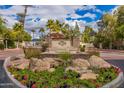 Gated community entrance with a fountain and landscaping at 10080 E Mountainview Lake Dr # 242, Scottsdale, AZ 85258