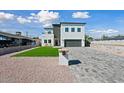 Stunning two-story modern home with a landscaped front yard and paved driveway at 1010 E Indianola Ave, Phoenix, AZ 85014