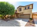 Two-story house with stone accents and a two-car garage at 1059 W Caroline Ln, Tempe, AZ 85284