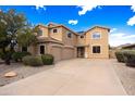 Two-story home with a three-car garage, desert landscaping, and a paved driveway at 12503 S 175Th Ave, Goodyear, AZ 85338