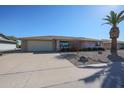 Brick ranch home with a two-car garage and mature landscaping at 12619 N Sun Valley Dr, Sun City, AZ 85351