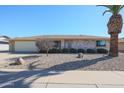 Brick ranch home with a two-car garage and mature landscaping at 12619 N Sun Valley Dr, Sun City, AZ 85351