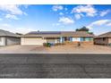 House exterior with solar panels and a brick facade at 12630 W Crystal Lake Dr, Sun City West, AZ 85375