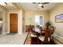 Formal dining room with wood table and chairs, near entryway at 13105 W Micheltorena Dr, Sun City West, AZ 85375