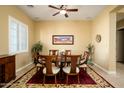 Formal dining room features a wood table and six chairs at 13105 W Micheltorena Dr, Sun City West, AZ 85375