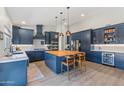 Renovated kitchen, featuring blue cabinetry, an island, and stainless steel appliances at 1618 E Montoya Ln, Phoenix, AZ 85024