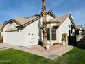 Charming single-story home with well-maintained lawn and mature landscaping at 1636 E Juanita Ave, Mesa, AZ 85204