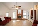 Living room with a brick fireplace and tile floors at 1636 E Juanita Ave, Mesa, AZ 85204