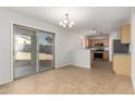 Bright dining area with tile floors and access to the backyard at 17840 W Calavar Rd, Surprise, AZ 85388