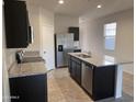 Modern kitchen with stainless steel appliances and granite countertops at 18227 N Conquistador Dr, Maricopa, AZ 85138