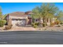 Spanish style home with a stucco exterior, tile roof, and a two-car garage at 18672 W Santa Irene Dr, Goodyear, AZ 85338