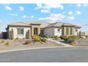 Single story home with desert landscaping and a three-car garage at 216 W Paoli St, San Tan Valley, AZ 85143