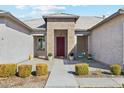 Inviting front entrance with a red door and well-manicured landscaping at 216 W Paoli St, San Tan Valley, AZ 85143