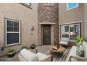 Charming courtyard with stone accents, seating area, and well-lit entrance, creating an inviting outdoor space at 21809 N 39Th St, Phoenix, AZ 85050