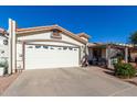 Exterior view showcasing the garage and a partially visible covered patio at 2329 N Recker Rd # 94, Mesa, AZ 85215