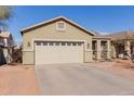 Tan house with a two-car garage and walkway at 244 W Wier Ave, Phoenix, AZ 85041