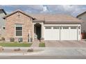 Single-story home with stone and stucco exterior, three-car garage, and landscaped front yard at 26123 N 20Th Dr, Phoenix, AZ 85085