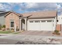 Single-story home with stone and stucco exterior, three-car garage, and landscaped front yard at 26123 N 20Th Dr, Phoenix, AZ 85085