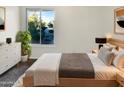 Main bedroom with a large window, ample closet space, and wood-like flooring at 2843 E Pershing Ave, Phoenix, AZ 85032