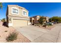 Two-story house with tan exterior, two-car garage, and landscaping at 3104 W Carlos Ln, San Tan Valley, AZ 85144