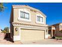 Two-story house with tan exterior, two-car garage, and landscaping at 3104 W Carlos Ln, San Tan Valley, AZ 85144