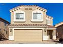 Two-story house with tan exterior, two-car garage, and landscaping at 3104 W Carlos Ln, San Tan Valley, AZ 85144