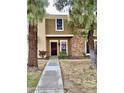 Tan two-story townhome with a red door and walkway at 3329 W Mcrae Way # 4, Phoenix, AZ 85027