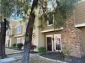 Tan two-story townhome with brick accents and landscaping at 3329 W Mcrae Way # 4, Phoenix, AZ 85027