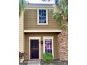 Tan two-story townhome with a red door and walkway at 3329 W Mcrae Way # 4, Phoenix, AZ 85027