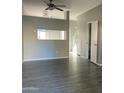 Bright living room with grey walls, wood-look floors, and a pass-through at 3329 W Mcrae Way # 4, Phoenix, AZ 85027