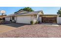 House exterior showcasing a two-car garage and gated side yard at 3519 W Emig Rd, Phoenix, AZ 85053