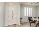 Interior entryway with a white door and dining area at 42593 W Falling Star Ct, Maricopa, AZ 85138