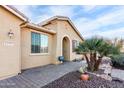 House exterior showcasing a tan facade and landscaping at 42593 W Falling Star Ct, Maricopa, AZ 85138