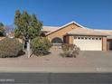 Single-story house with a two-car garage and mature trees at 4302 E Rockledge Rd, Phoenix, AZ 85044