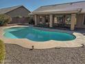 Inviting kidney-shaped pool surrounded by gravel at 4302 E Rockledge Rd, Phoenix, AZ 85044