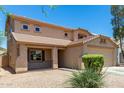 Two-story house with a covered porch and two-car garage at 43864 W Elizabeth Ave, Maricopa, AZ 85138