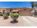 Two-story house with a two-car garage and desert landscaping at 43864 W Elizabeth Ave, Maricopa, AZ 85138