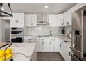 Modern kitchen with white cabinets, quartz countertops, and stainless steel appliances at 538 N 74Th St, Scottsdale, AZ 85257