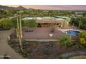 Aerial view of a home with a pool, covered patio, and desert landscaping at 5730 E Cielo N Run, Cave Creek, AZ 85331