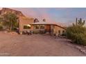 Southwest style home with mountain backdrop, inviting entry, and desert landscaping at 6013 E Lost Dutchman Blvd, Apache Junction, AZ 85119