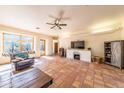 Spacious living room with tile floors, fireplace, and ample seating at 6052 N 183Rd Ave, Waddell, AZ 85355