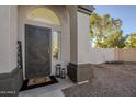 Front entry with decorative door, welcome mat, and lanterns at 669 S Saddle St, Gilbert, AZ 85233