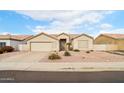 Single-story house with a two-car garage and stone pathway at 7138 E Laguna Azul Ave, Mesa, AZ 85209