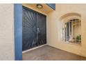 Condo entry with black metal doors and a small window at 8413 N 55Th Ave, Glendale, AZ 85302