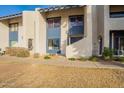 Front view of a tan condo with blue accents and landscaping at 8413 N 55Th Ave, Glendale, AZ 85302