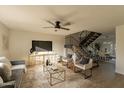 Living room with gray sofa, gold accents, and a staircase at 8413 N 55Th Ave, Glendale, AZ 85302