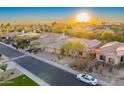 Aerial view of house and neighborhood with a sunset at 9690 N 117Th Way, Scottsdale, AZ 85259