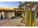 Front entrance to a lovely home with a large, mature cactus plant at 9690 N 117Th Way, Scottsdale, AZ 85259