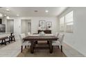 Inviting dining room featuring a wooden table, neutral colors, and natural light at 10031 E Gamma Ave, Mesa, AZ 85212