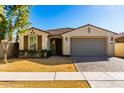 Charming single-story home featuring a low-maintenance yard and a convenient two-car garage at 10031 E Gamma Ave, Mesa, AZ 85212